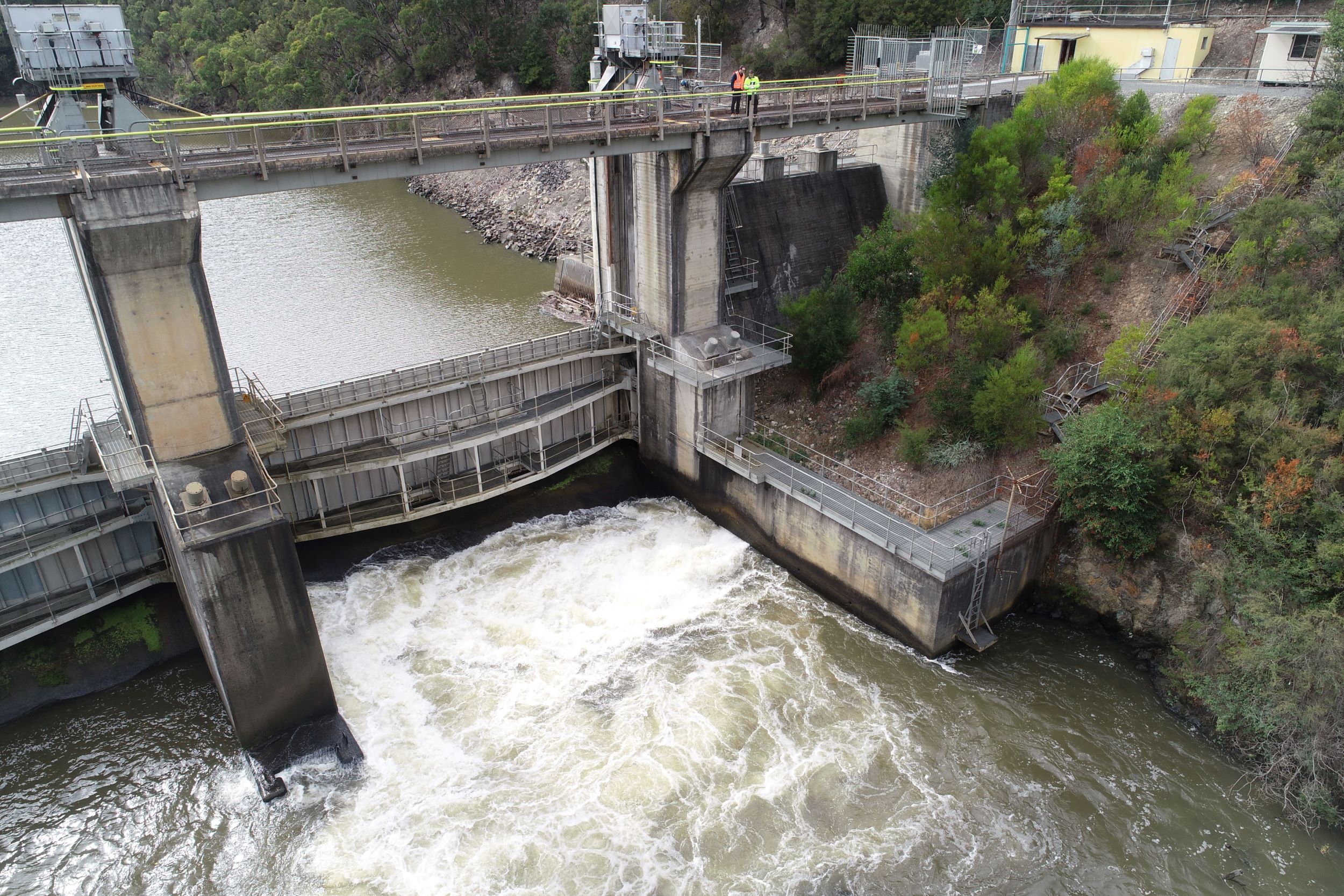 Two people looking down from the Narracan dam wall.