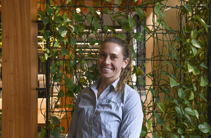 Woman smiling in front of plants indoors