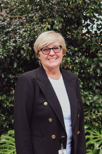 Blonde short haired woman smiling at camera